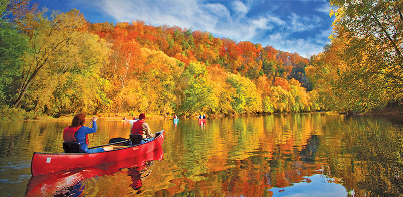 Canoeing along the James River amidst beautiful fall foliage.