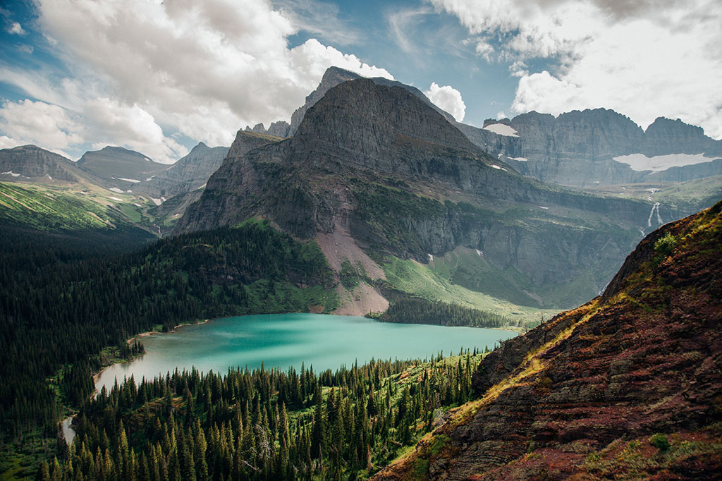 The mountains of Glacier National Park rise above a glacial lake.