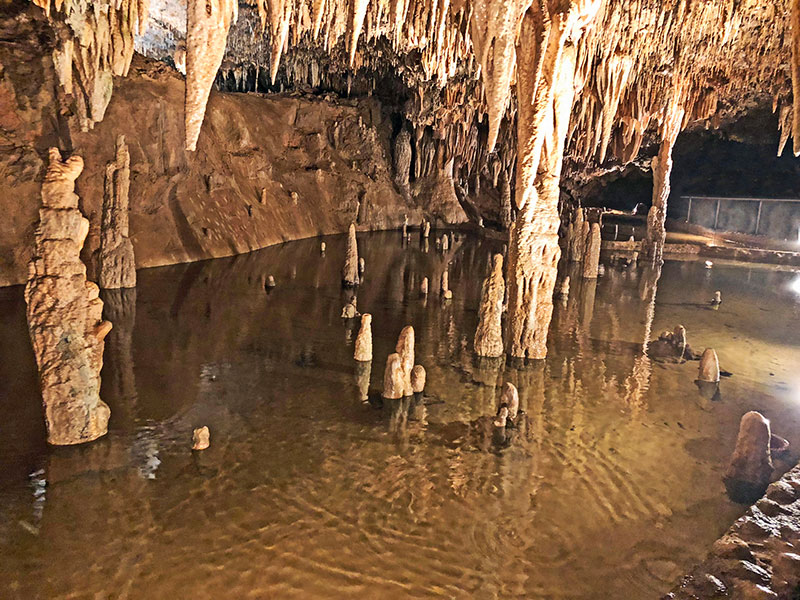 Water and cave formations inside Meramac Caverns in Missouri