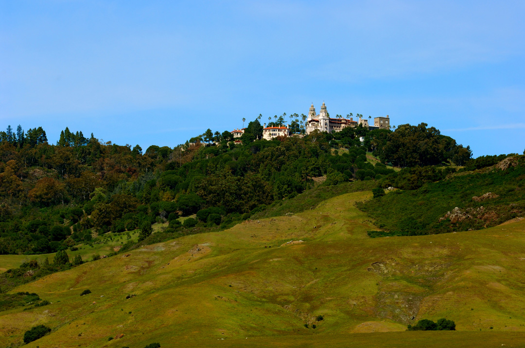 Hearst Castle on top of grassy hills as viewed from the Coast Highway