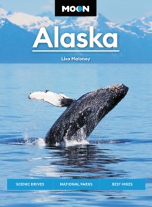 Cover of the Moon Alaska travel guide featuring a breaching whale