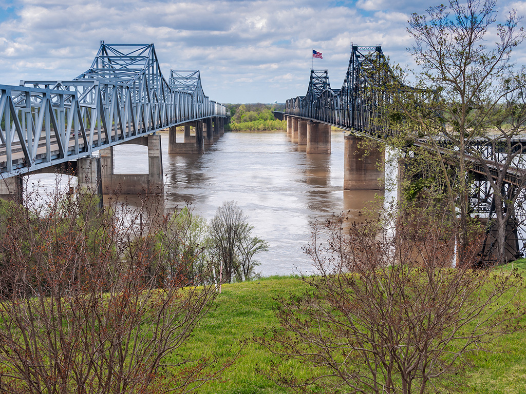 two bridges span a muddy river