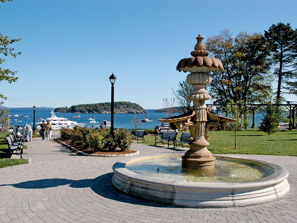 fountain with a waterfront in the distance