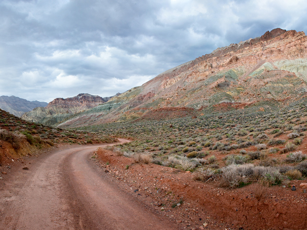 dirt road winding through titus canyon in death valley