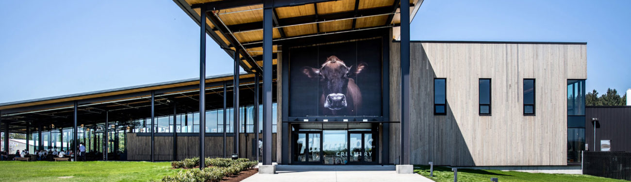 Exterior of the Tillamook Creamery building with a large image of a cow on the front