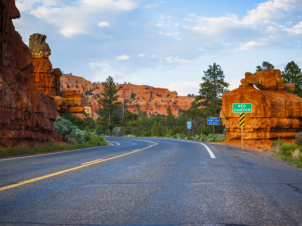 two-lane road winding through red canyon in utah