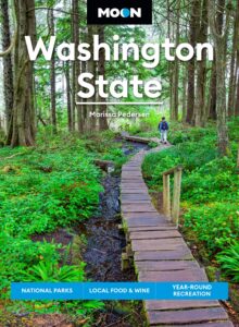 Book jacket with image of person walking on boardwalk in forest with text Moon Washington State