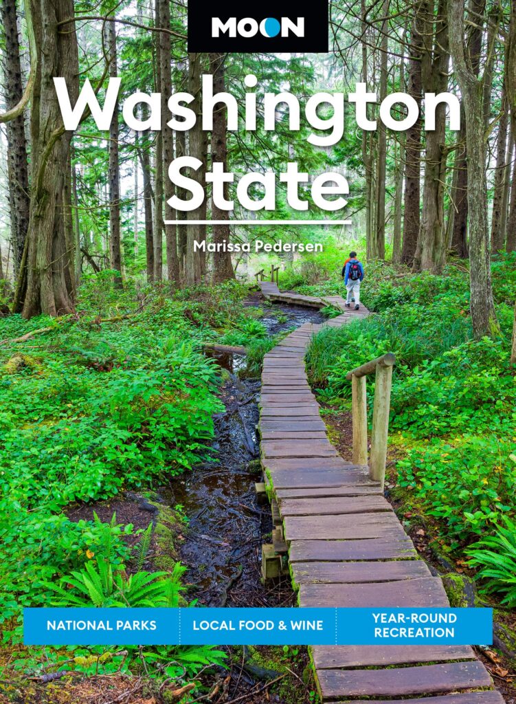 Book jacket with image of person walking on boardwalk in forest with text Moon Washington State